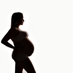 Silhouette of a pregnant woman by maternity photographer norfolk