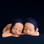 Beautiful Newborn twin baby boys posed on a navy blanket by newborn photographer in Norfolk