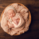 Beautiful Newborn baby girl posed in a bowl by newborn photographer in Norfolk