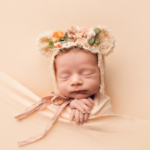 Beautiful Newborn baby girl wearing a bear bonnet by newborn photographer in Norfolk