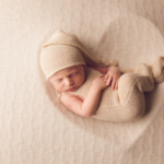 Beautiful Newborn baby boy posed in a heart bowl by newborn photographer in Norfolk