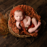 Beautiful Newborn baby boy posed in a basket by newborn photographer in Norfolk
